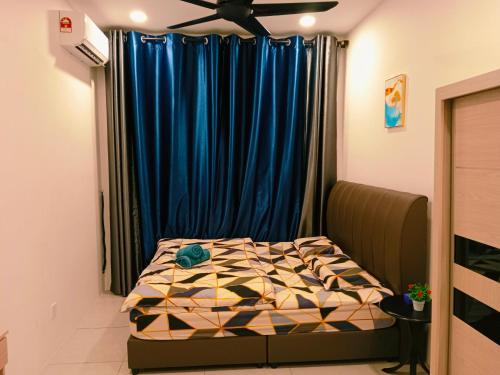 a bedroom with a bed in front of a blue curtain at Preferred30 3R2B 7pax Meritus Perai in Perai