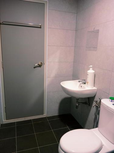 a bathroom with a toilet and a sink at Preferred30 3R2B 7pax Meritus Perai in Perai