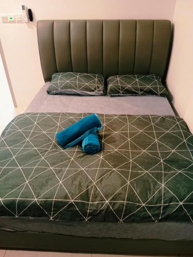 a bed with a blue pillow on top of it at Preferred30 3R2B 7pax Meritus Perai in Perai