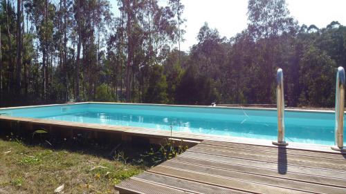 a swimming pool next to a wooden deck at RiverHouse - Near River - Near Ocean - Near Porto in Porto