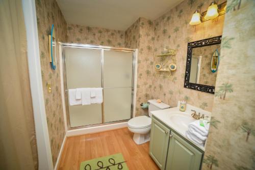 a bathroom with a shower and a toilet and a sink at True Blue Golf Resort in Pawleys Island