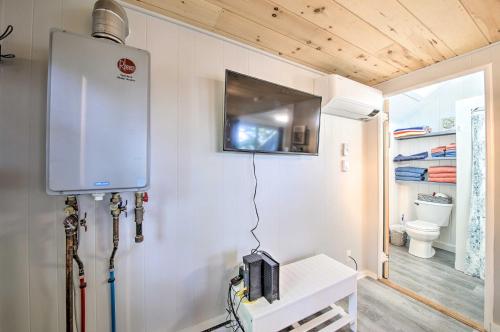 a room with a heater and a toilet in a room at Lush Edgecomb Studio Cottage with Fire Table! in Edgecomb
