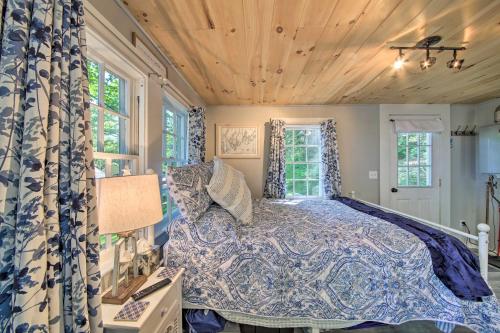 a bedroom with a bed in a room with windows at Lush Edgecomb Studio Cottage with Fire Table! in Edgecomb