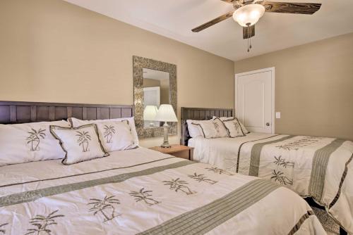 a bedroom with two beds and a ceiling fan at Chic Maricopa Getaway with Outdoor Oasis and Pool in Maricopa