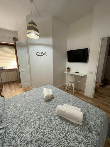 a bedroom with a bed with two towels on it at Aria di mare in Civitavecchia