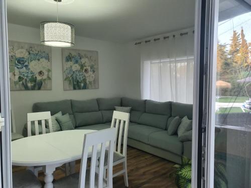 a living room with a couch and a table at Chalet Brisas del Mar in Chiclana de la Frontera