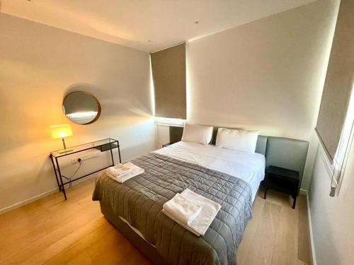 a small bedroom with a bed and a mirror at Luxury Apartment in Nicosia By Platform 357 in Nicosia