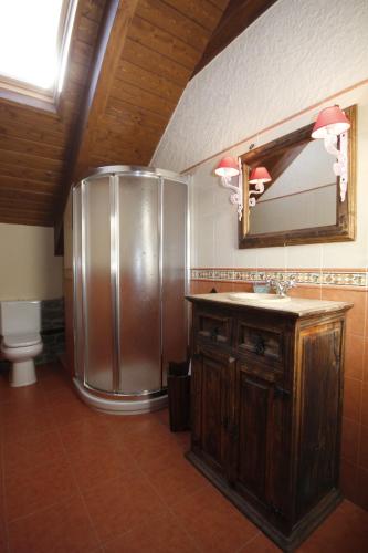 a large metallic refrigerator in a bathroom with a sink at Casa Rural Perico in Fiscal