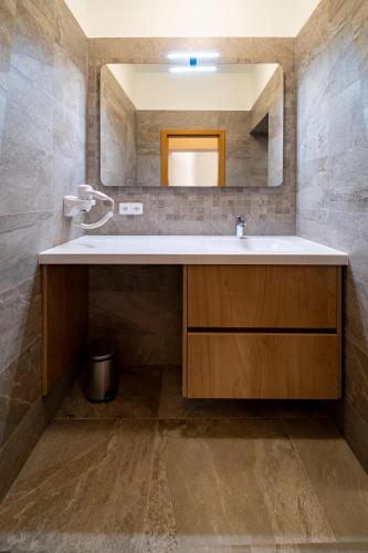 a bathroom with a sink and a mirror at Relax Hotel Stork in Lednice