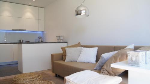 salon z kanapą i kuchnią w obiekcie Home3city Nadmorski Dwór w Gdańsku