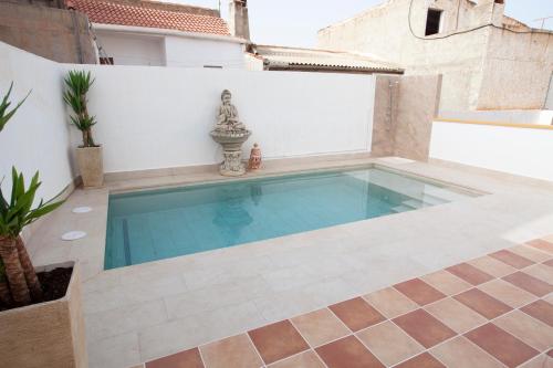 a swimming pool in the backyard of a house at El Palacete de Cuevas in Cuevas del Almanzora