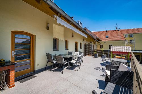 a patio with chairs and a table on a balcony at Relax Hotel Stork in Lednice