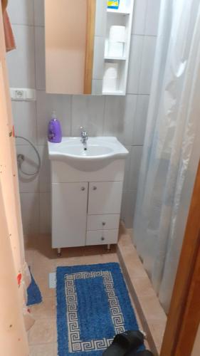 a bathroom with a sink and a shower curtain at Apartman Panorama in Jajce