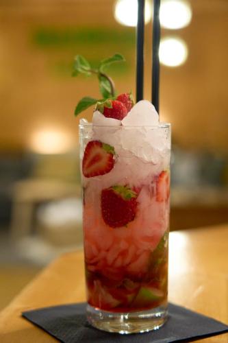 a drink with strawberries and whipped cream on a table at Madrisa Lodge in Klosters