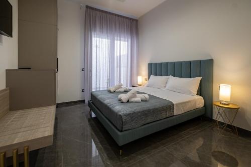 a bedroom with a bed with two stuffed animals on it at Moonlight B&B in Porto Cesareo