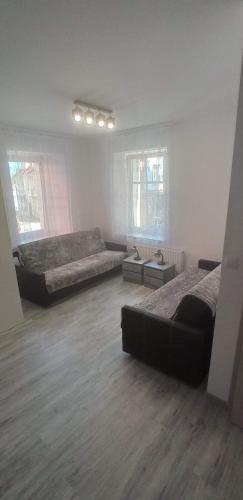 a large room with two beds and a couch at Apartament Po schodkach in Duszniki Zdrój