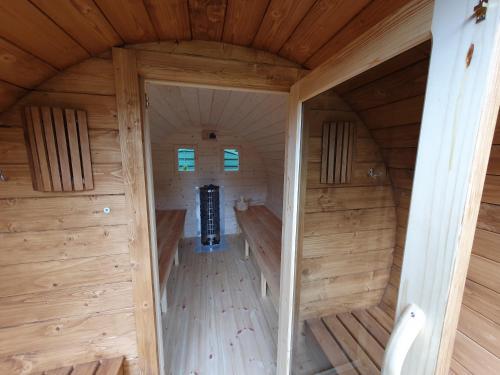 an inside view of a wooden cabin with a sauna at Domki Niesiołowice in Niesiołowice