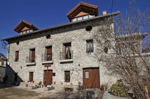 a large stone building with a tower on top of it at Casa Rural Perico in Fiscal