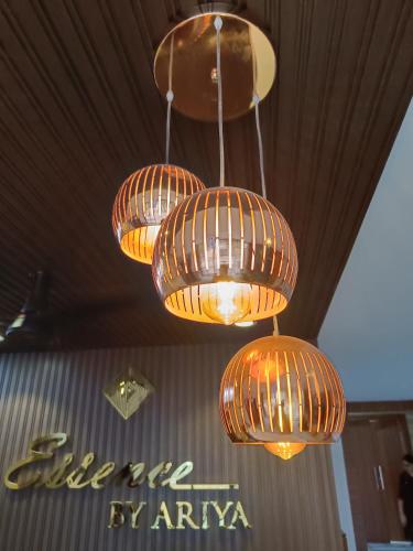 a group of lights hanging from a ceiling at Hotel ESSENCE in Vellore