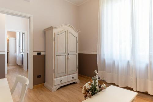 a white cabinet in a room with a table at Villa Romantica Wellness & SPA in Lucca