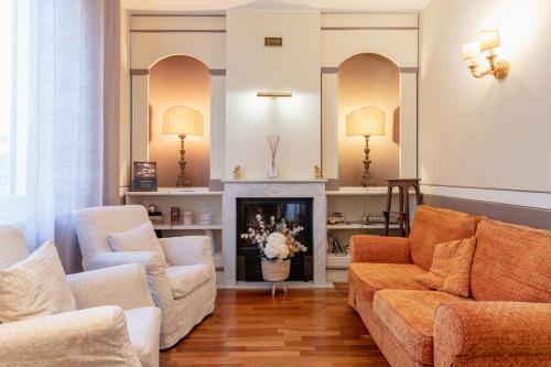 a living room with a couch and a fireplace at Villa Romantica Wellness & SPA in Lucca