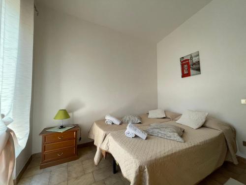 Un dormitorio con dos camas y una mesita de noche con lámpara. en Casa Panorama, en Posada