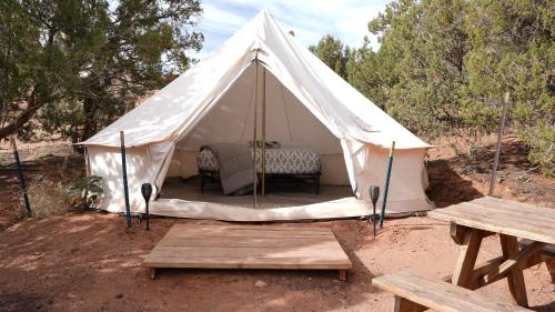 a white tent with a table and a bench at Zion View Camping in Hildale
