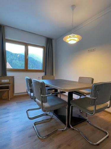a dining room with a table and chairs at Hotel & Suites Glück Auf in Mayrhofen