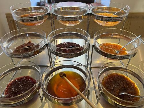 a group of glass bowls filled with different types of food at Hotel Praha in Broumov