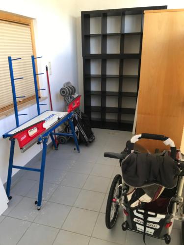 a bike parked in a room with a table at FitApartman in Mitterfirmiansreut