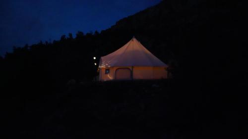 a tent with a white top at night at Zion View Camping in Hildale