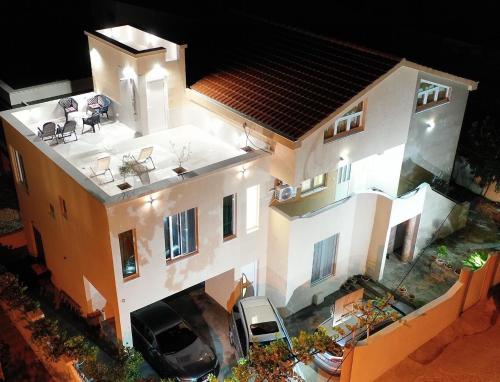 an overhead view of a house with a car parked in front at ID apartments in Tivat