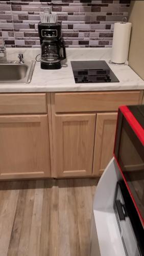 a kitchen with a sink and a stove top oven at JAMMS tiny home in Baton Rouge