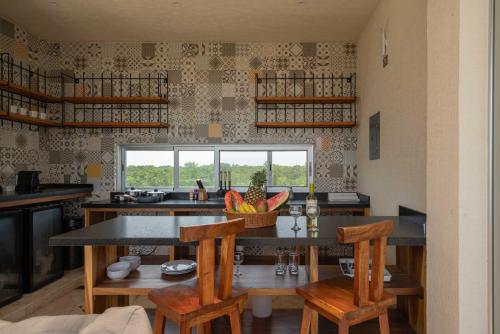 a kitchen with a table and chairs and a window at Valhalla Residences by Biwa in Tulum