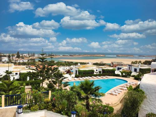 an aerial view of a resort with a swimming pool and the beach at Maison Oualidia Vue sur Mer-Jardins de la Lagune in Oualidia