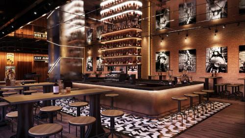 a bar with stools and tables in a restaurant at Holiday Inn Resort Ho Tram Beach by IHG in Ho Tram