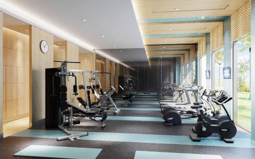 a gym with a row of treadms and machines at Holiday Inn Resort Ho Tram Beach by IHG in Ho Tram