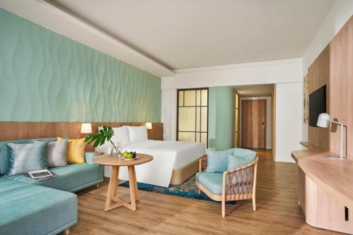 a hotel room with a bed and a couch at Holiday Inn Resort Ho Tram Beach by IHG in Ho Tram