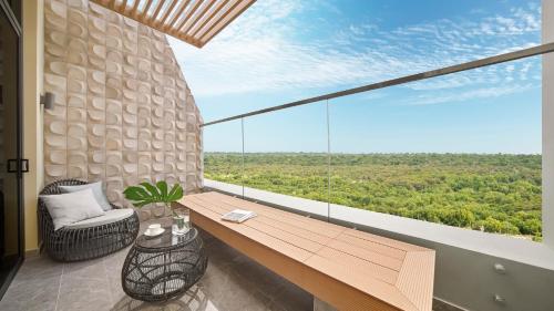 a room with a wooden bench and a large window at Holiday Inn Resort Ho Tram Beach by IHG in Ho Tram