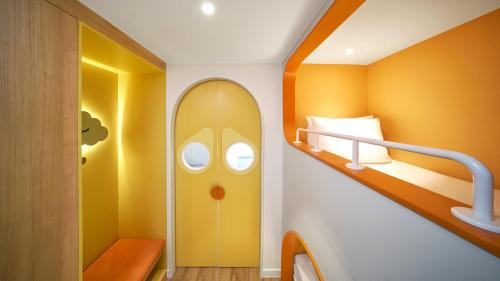 a small room with a bunk bed and a staircase at Holiday Inn Resort Ho Tram Beach by IHG in Ho Tram