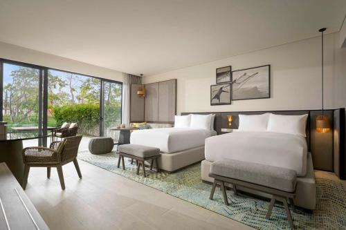 a hotel room with two beds and a living room at Crowne Plaza Phu Quoc Starbay by IHG in Phu Quoc