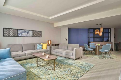a living room with two couches and a table at Crowne Plaza Phu Quoc Starbay by IHG in Phu Quoc