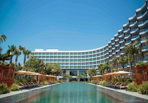 a hotel with a swimming pool in front of a building at Crowne Plaza Phu Quoc Starbay by IHG in Phu Quoc