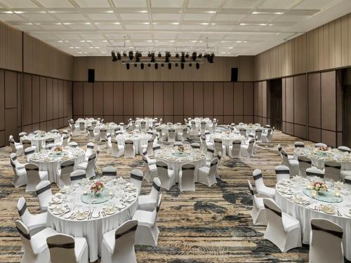 a large banquet hall with white tables and chairs at Crowne Plaza Phu Quoc Starbay by IHG in Phu Quoc