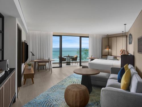 a hotel room with a bed and a living room at Crowne Plaza Phu Quoc Starbay by IHG in Phu Quoc