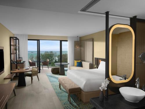 a hotel room with a bed and a bathroom at Crowne Plaza Phu Quoc Starbay by IHG in Phu Quoc