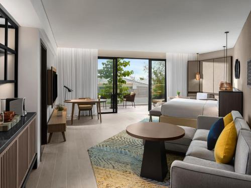 a hotel room with a bed and a living room at Crowne Plaza Phu Quoc Starbay by IHG in Phu Quoc