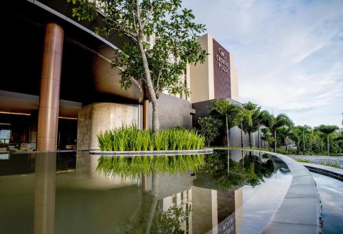 a building with a reflecting pool in front of it at Crowne Plaza Phu Quoc Starbay by IHG in Phu Quoc