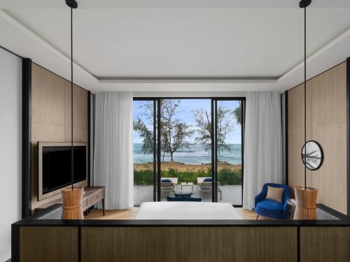 a living room with a bed and a large window at Crowne Plaza Phu Quoc Starbay by IHG in Phu Quoc