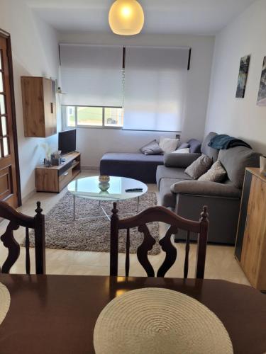 a living room with a couch and a table at PIso de 3 habitaciones en centro de Miño in Miño